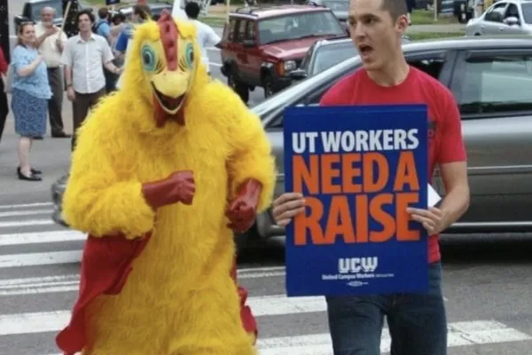 Picture of Cameron Brooks with Sign "UT Workers Need a Raise"